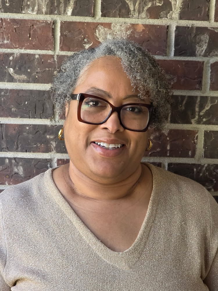 Meet Sandra Shields, Licensed Marriage and Family Therapist Sandra Shields smiling in front of a brick wall